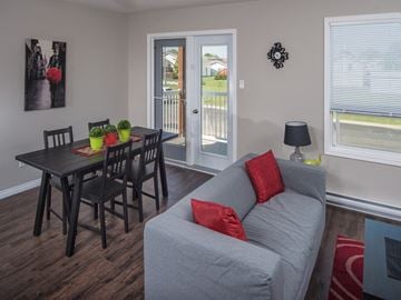 Brandon apartment for rent - a living room with a couch and a dining room table