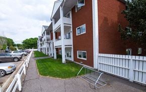 Brandon apartment for rent - a row of houses with cars parked in front of them