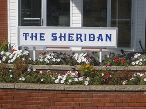 Brandon apartment for rent - a sign in front of flowers