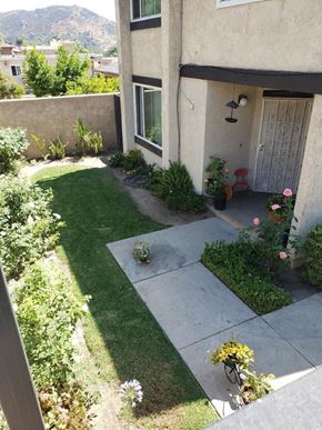 Los Angeles apartment for rent - a yard with grass and a house with a door