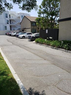 Los Angeles apartment for rent - a row of cars parked on the side of a street