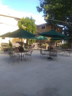 Los Angeles apartment for rent - an outdoor patio with tables and chairs and umbrellas