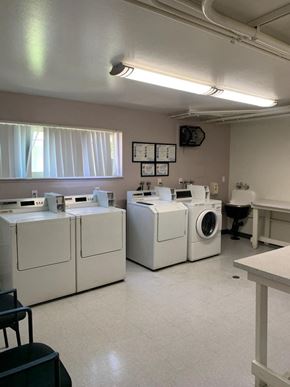 Los Angeles apartment for rent - a laundry room with four washes and a washing machine