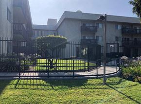 Reseda apartment for rent - an apartment building with a yard and a fence