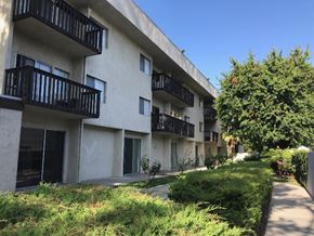 Reseda apartment for rent - an apartment building with multiple balconies and a sidewalk