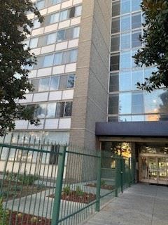 Los Angeles apartment for rent - a tall building with a green fence in front of it