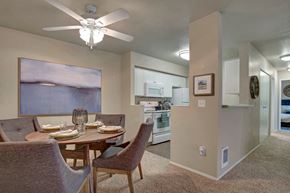 Mukilteo apartment for rent - a dining room table with chairs and a ceiling fan