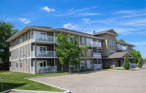 Brandon apartment for rent - a three story apartment building with balconies and trees