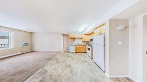 Brandon apartment for rent - a spacious kitchen with white appliances and wooden floors