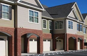Winchester apartment for rent - a brick house with white garage doors