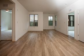 Charlottesville apartment for rent - A room with wooden floors and white walls.