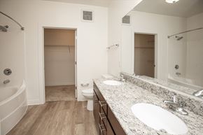 Charlottesville apartment for rent - A white bathroom with a tub, toilet, and sink.