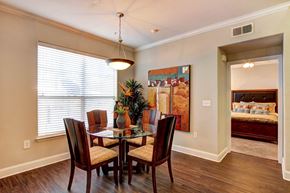 Houston apartment for rent - a dining room with a table and chairs and a large window