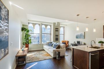 Spokane apartment for rent - a living room with a couch and a kitchen with a sink