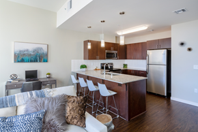 Spokane apartment for rent - a kitchen and living room with a large island and stainless steel appliances