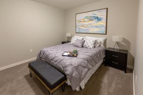 Spokane apartment for rent - a bedroom with a large bed and a painting on the wall