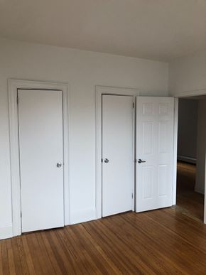 Jersey City apartment for rent - three doors in a room with wood floors and white walls
