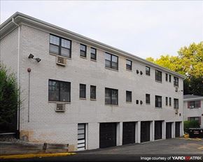 North Plainfield apartment for rent - A white building with black garage doors.