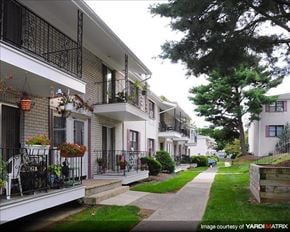 North Plainfield apartment for rent - A row of white houses with balconies and flower pots.