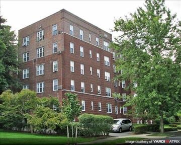 Montclair apartment for rent - A red brick building with a green tree in front.