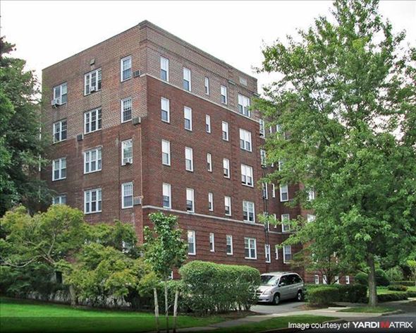 Montclair apartment for rent - A red brick building with a green tree in front.