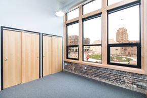 Sioux City apartment for rent - a room with large windows and a brick wall