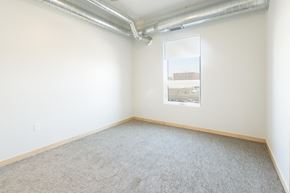 Sioux City apartment for rent - an empty room with a window and a carpeted floor