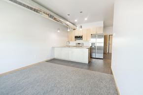 Sioux City apartment for rent - a kitchen with a white counter top and a stainless steel refrigerator