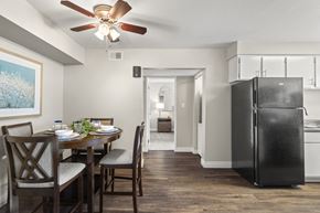 Mesa apartment for rent - A black refrigerator is in a kitchen with a dining table and chairs.