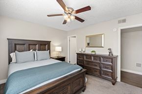 Mesa apartment for rent - A bedroom with a bed, nightstand, and a ceiling fan.