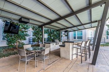 Trellised outdoor dining and grilling areas