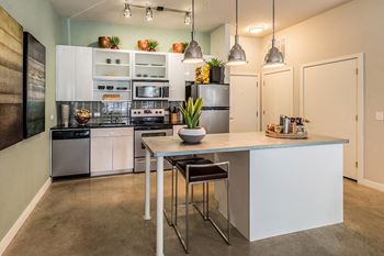 Open-concept gourmet kitchens with granite slab islands