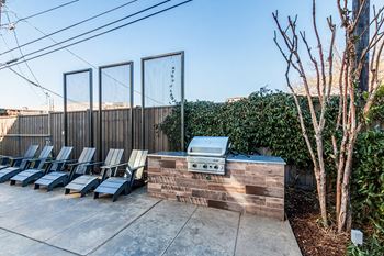 Trellised outdoor dining and grilling areas