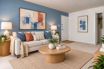 Silver Spring apartment for rent - A living room with a white couch, a coffee table, and a painting on the wall.