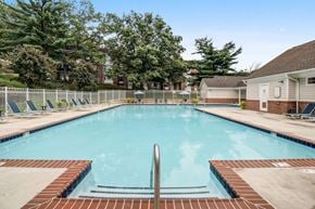 Silver Spring apartment for rent - a swimming pool with chairs and a house in the background
