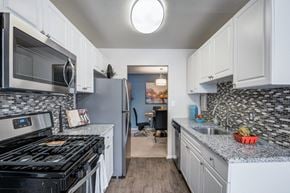 Silver Spring apartment for rent - a kitchen with stainless steel appliances and granite counter tops