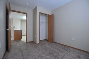 Ligonier apartment for rent - a bedroom with a carpeted floor and a door to a closet