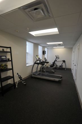 Connersville apartment for rent - A gym room with a treadmill, elliptical trainer and weights.