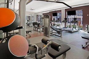 Metuchen apartment for rent - a gym with weights and other exercise equipment in a building with windows
