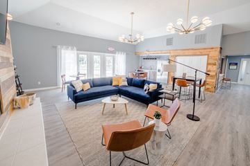 Indianapolis apartment for rent - a living room with blue couches and chairs and a dining room with a kitchen