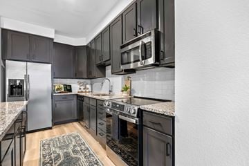 Denver apartment for rent - A kitchen with black cabinets and stainless steel appliances.