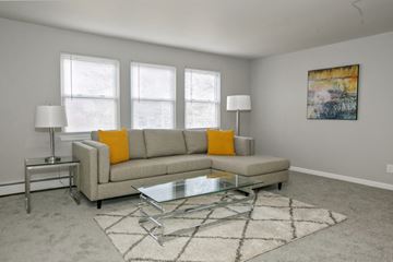 Madison apartment for rent - a living room with a couch and a glass coffee table