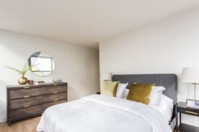 Chicago apartment for rent - a bedroom with a bed and a dresser with a mirror
