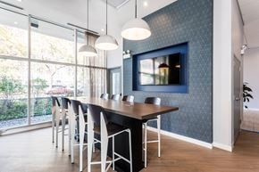 Chicago apartment for rent - a dining room with a table and chairs and a tv on the wall