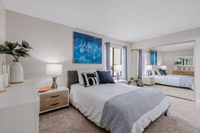 Santa Ana townhouse for rent - a bedroom with a bed and a large mirror
