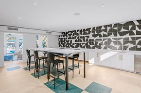 Santa Ana townhouse for rent - a kitchen with a table and chairs and a geometric wall