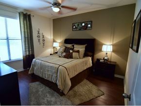 Irving apartment for rent - a bedroom with a bed and a ceiling fan