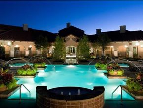 Irving apartment for rent - a large swimming pool in front of a hotel at night