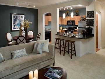Irving apartment for rent - A living room with a grey couch and a coffee table with candles on it.