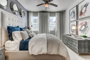 Irving apartment for rent - Beautiful open bedroom ,ceiling fan, plush carpet, two large windows, king size bed with night stand and dresser, three small mirrors above headboard. 4 large art pieces above dresser.